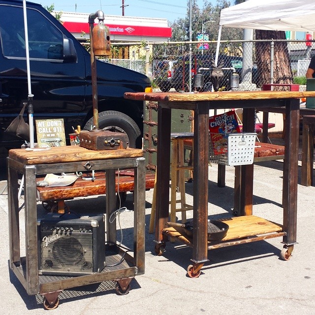 The vendor in B22 showcases his reclaimed industrial  furniture pieces next to artwork he purchased at #MTPfairfax.